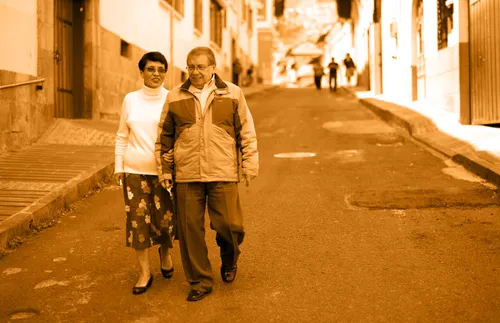 a couple walking down a city street