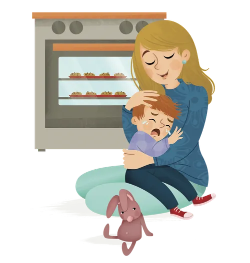 Mom hugging a crying boy on the kitchen floor in front of an oven
