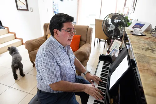 man playing the piano and singing