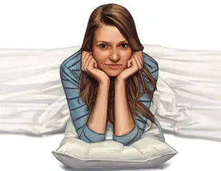 young woman propped on pillow