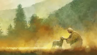 Jesus Christ is stooped down and feeding a small lamb in a large meadow in the mountains.