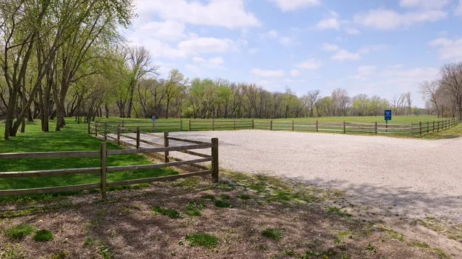 Exterior image of a gravel path surrounded by grassy fields. This is part of the Hawn's Mill Historic Site.