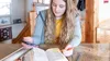 girl studying and marking scriptures with help from a smartphone and lesson manual