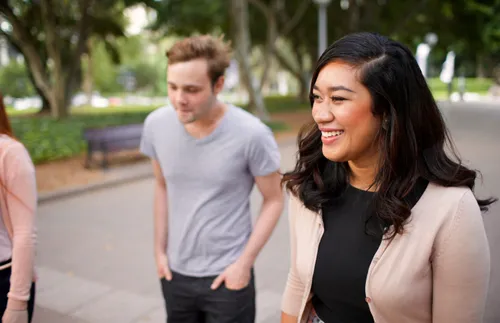 young adults smiling and walking together