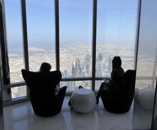 two people looking out from skyscraper windows