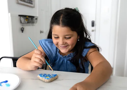 Girl painting a rock
