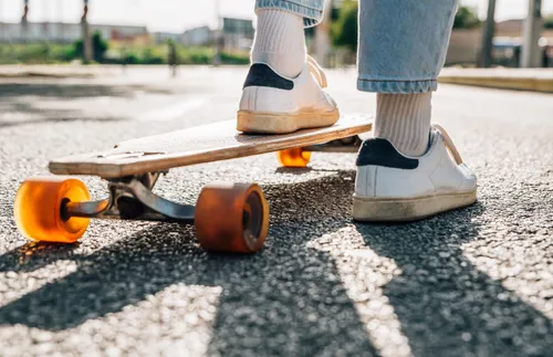 feet standing on a skateboard
