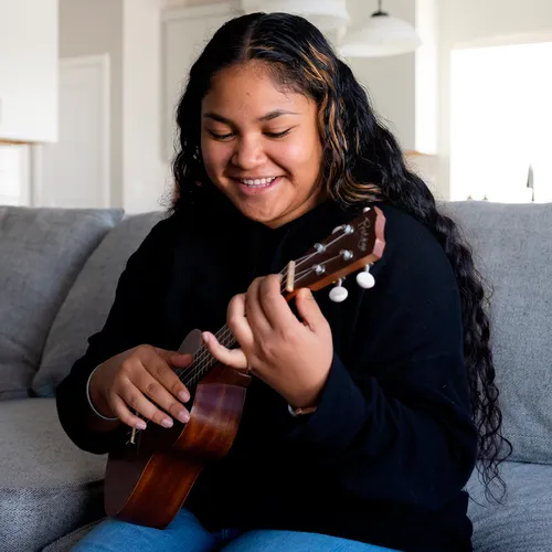 young woman playing ukulele