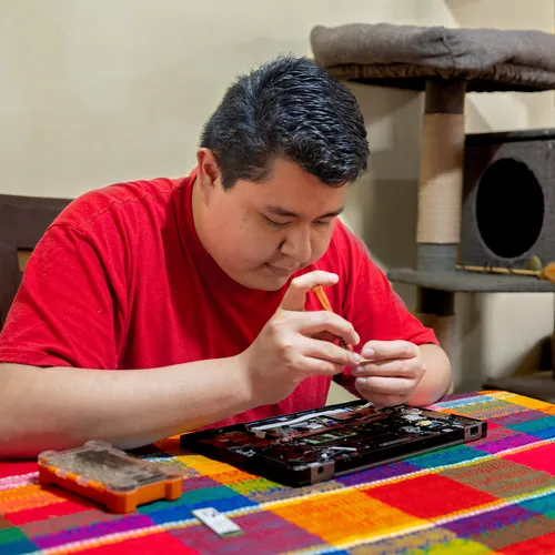 young man working on computer hardware