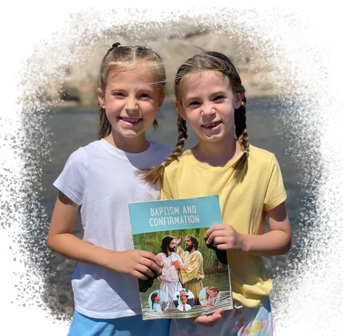Twin girls holding a copy of the Baptism and Confirmation issue of the Friend magazine