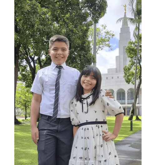 Boy and girl standing in front of the temple