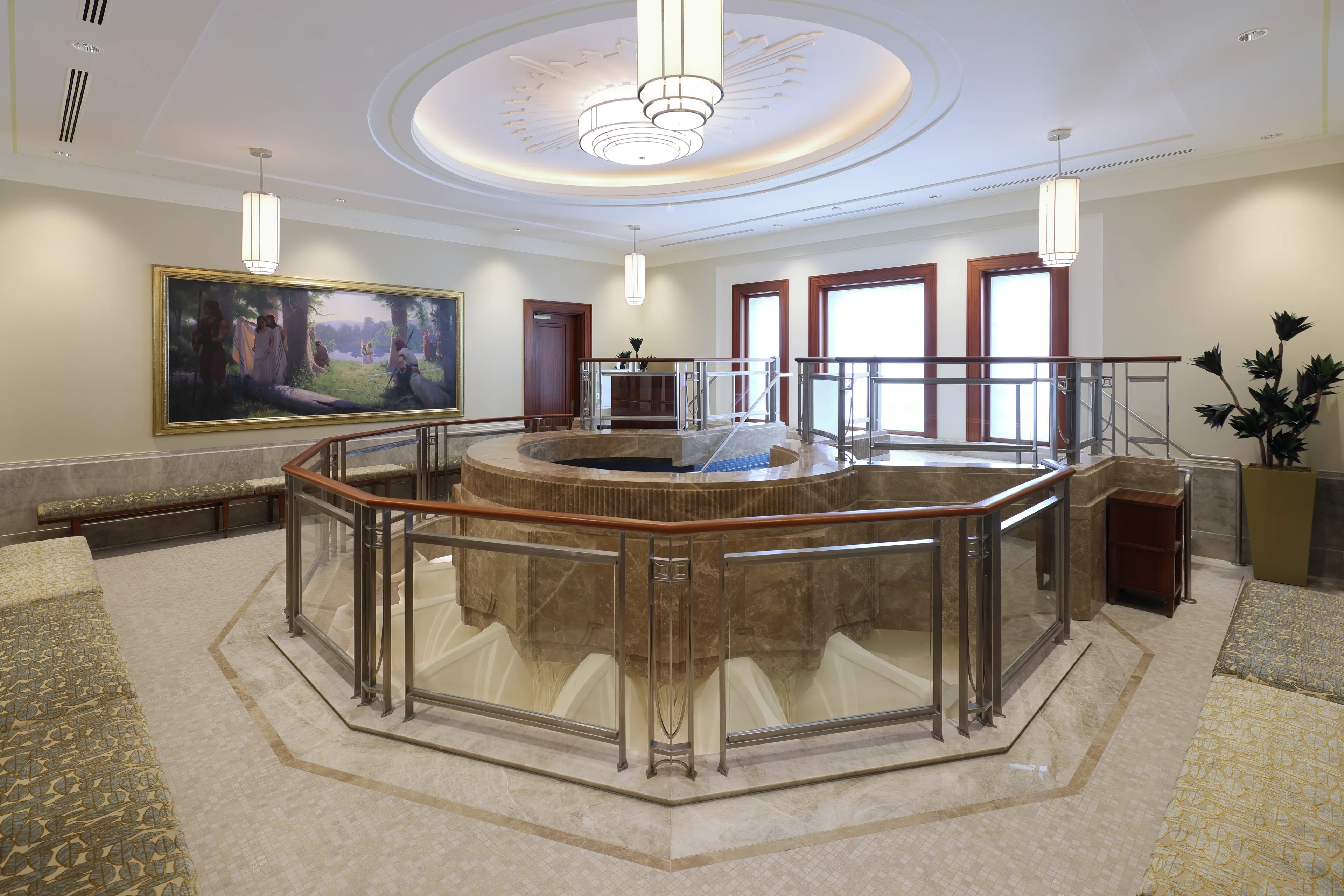 Interior image of the Abidjan Ivory Coast Temple featuring the baptistry. The image highlights the font with art on walls of the room. © undefined ipCode 1.