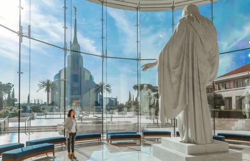 woman standing in front of Christus statue